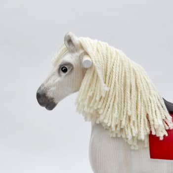 Detail on head of wooden rocking horse, white colors