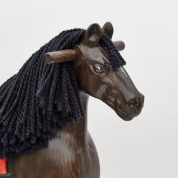 Detail on head of wooden rocking horse, black colors